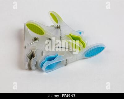 Plastic colorful clothes line pegs on white background Stock Photo