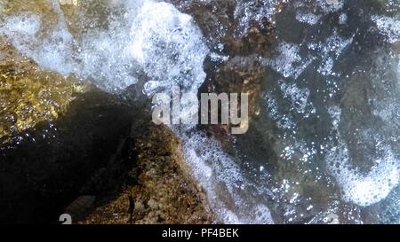 Waves on the rocks Stock Photo