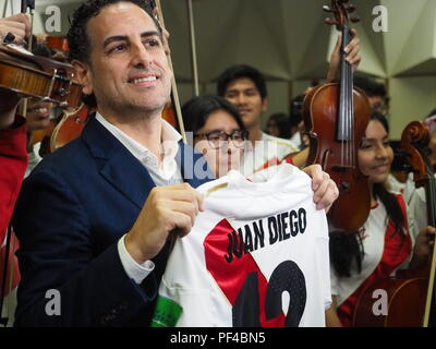 The operatic tenor Juan Diego Florez, together with the children of the Symphony  for Peru Orchestra wearing Peruvian soccer jerseys, singing to the Peruvian soccer team one day before the match against Australia in the Russia 2018 World Cup.