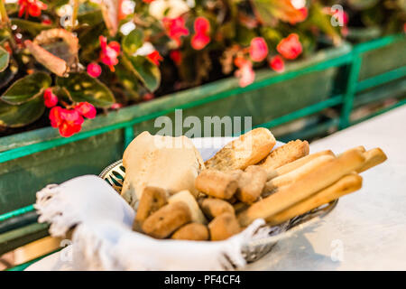 Basket of breads and breadsticks on a table of restaurant Stock Photo