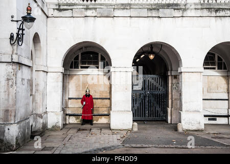 London, United Kingdom - January 18 2018: Member of the the British Household Cavalry Guards,  wearing a red uniform on the Royal horse guards building Stock Photo