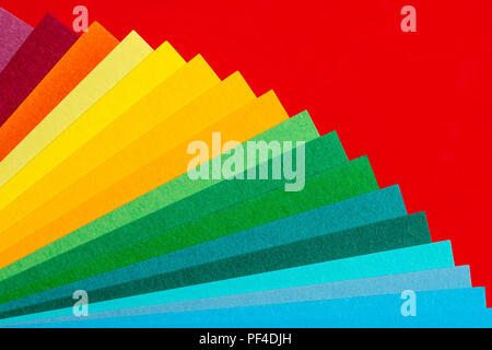 A fan deck of colors on a red background. Stock Photo