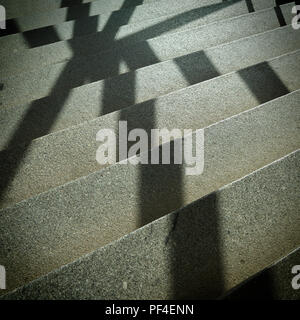 Shadow of a window grille on the steps of a staircase Stock Photo