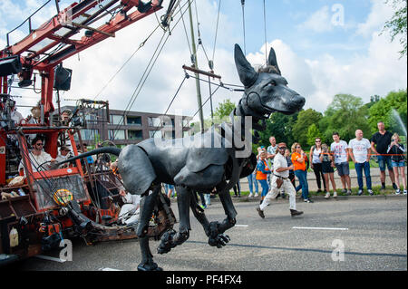 Leeuwarden, The Netherlands, 18th August, 2018. The world-famous production of Royal de Luxe makes its Dutch premiere in the European Capital of Culture. These towering giants walk the streets of Leeuwarden and provide an unforgettable experience with their 'Big Skate in the Ice' show. Royal de Luxe is an extraordinary street theatre company.  Twenty people are needed to make her move and she is Credit: Ricardo Hernandez/Alamy Live News Stock Photo