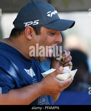Los Angeles, USA. 18th Aug, 2018. A man enjoys his barbecue meat at the Long Beach BBQ Festival in Long Beach, Los Angeles County, the United States, Aug. 18, 2018. The three-day BBQ festival kicked off on Friday. Credit: Li Ying/Xinhua/Alamy Live News Stock Photo