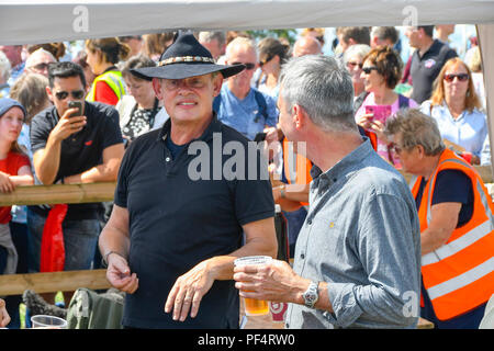 Beaminster, Dorset, UK.  19th August 2018. UK Weather.  Actor Martin Clunes with Actor Neil Morrissey who has a pint of lager at Buckham Fair at Beaminster, Dorset.  Picture Credit: Graham Hunt/Alamy Live News Stock Photo