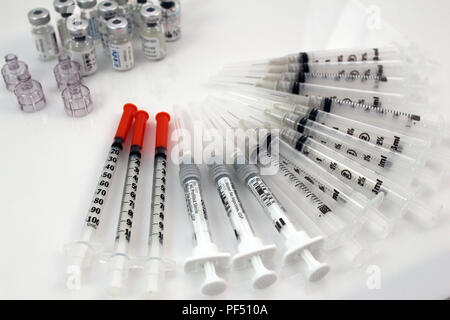 Syringes and medical vials for IVF treatment on a white background Stock Photo