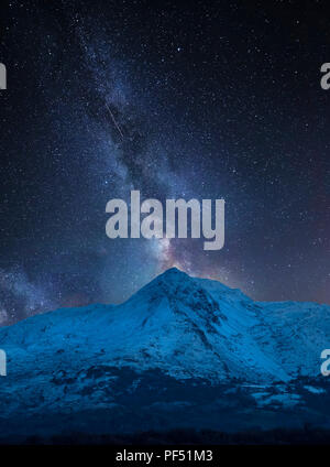 Stunning vibrant Milky Way composite image over landscape of Mount Snowdon and other peaks in Snowdonia National Park Stock Photo
