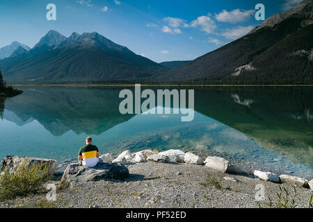 Man Reading in Quiet Contemplation, Spray Lake, Alberta, Canada Stock Photo