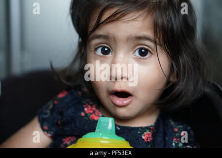 Baby girl with a surprised expression of utter consternation on her face Stock Photo