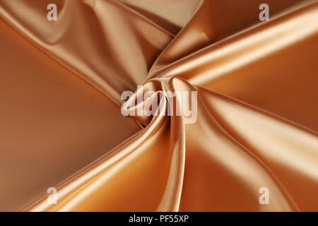 Smooth elegant golden silk or satin luxury cloth. Luxurious background design. golden silk wavy background Stock Photo