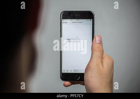 Customer Support Assistance Help Advice Client Concept, Asking a question online on a mobile phone Stock Photo