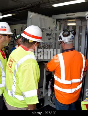U.S. Army Corps of Engineers Task Force Recovery is a federal emergency response element overseeing infrastructure restoration missions. The archival image records senior staff reviewing operational requirements of the Yabucoa Substation mega-generator in Yabucoa, Puerto Rico, on August 14, 2018, after the Puerto Rico Electric Power Authority determined sufficient grid capacity and requested demobilization during Hurricane Maria recovery efforts. Stock Photo