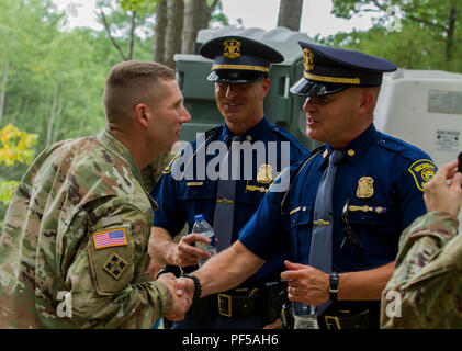 Sergeant Major of the Army Dan Dailey shakes hands with Michigan State Police Troopers prior to viewing a demonstration by the 126th Infantry Regiment at Camp Grayling, MI, August 15, 2018. SMA Dailey is visiting as part of Northern Strike 18, a National Guard Bureau-sponsored exercise uniting service members from many states, multiple service branches and a number of coalition countries during the first three weeks of August 2018 at the Camp Grayling Joint Maneuver Training Center and the Alpena Combat Readiness Training Center, both located in northern Michigan and operated by the Michigan N Stock Photo