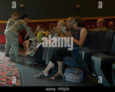 The family of Lt. Col. Shawn Reynolds, commander of the 136th Attack Squadron, 107th Operations Group, 107th Attack Wing, New York National Guard, are given tokens of appreciation from Airmen of the 107th during a change of command ceremony at Niagara Falls Air Reserve Station, N.Y., Aug. 11, 2018. The sacrifices and support of the family for Reynolds are recognized by the wing. (U.S. Air National Guard photo by Staff Sgt. Ryan Campbell) Stock Photo