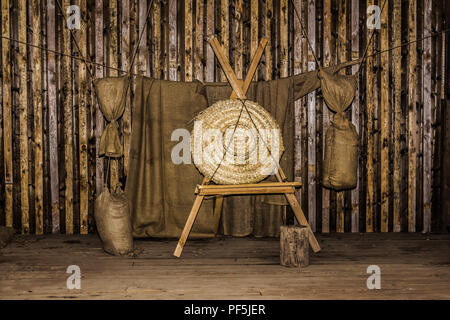 a straw target for archery trilling, which is in an old wooden barn, Stock Photo