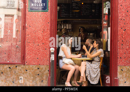 Two Paris girls chatting at Les Caves Populaires bar in the Batignolles area, 17th arrondissment. France, Europe. Stock Photo