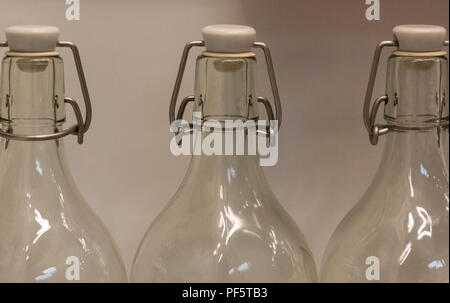 Three empty glass bottles standing in a row Stock Photo