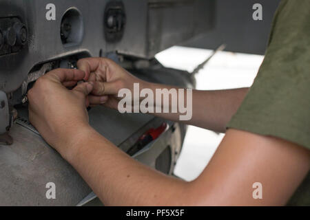 The GBU-32 Joint Direct Attack Munition is a 1,000-pound class precision-guided bomb kit that converts unguided bombs into GPS-guided munitions for the United States military. The archival image records an aviation ordnance technician from Marine Fighter Attack Squadron 115 removing a GBU-32 from a Boeing F/A-18 Hornet during maintenance operations in Southwest Asia. Stock Photo