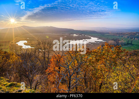 Sun going down over the lake at autumn Stock Photo