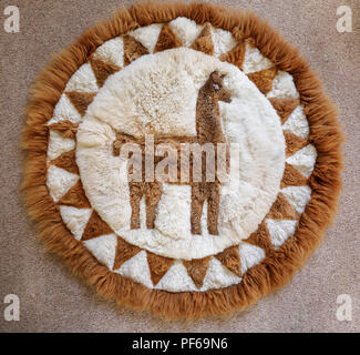 Typical Peruvian or Bolivian souvenir: a soft, fluffy patchwork rug hand crafted from pieces of alpaca skin to form a picture of an alpaca or llama Stock Photo