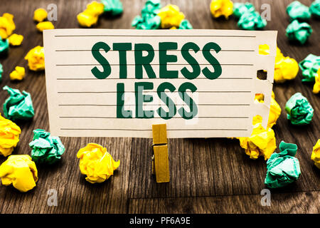 Text sign showing Stress Less. Conceptual photo Stay away from problems Go out Unwind Meditate Indulge Oneself Clothespin holding notebook paper crump Stock Photo
