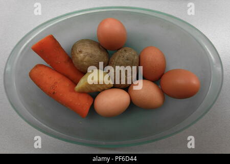 Boiled   eggs  and  vegetables  in  a glass plate Stock Photo