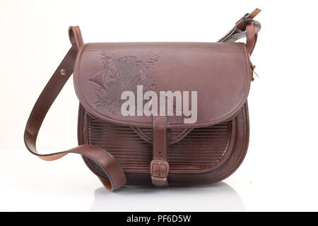 Leather hunting bag with brown ornament with patronage on white isolated background Stock Photo