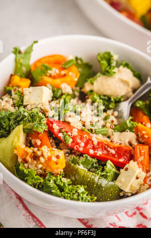 Healthy vegan salad with baked vegetables, quinoa and kale on white background. Clean eating concept. Stock Photo