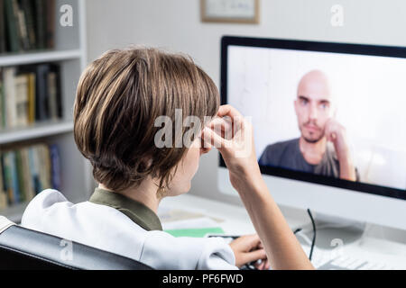 Digital health concept: practicing physician having online appointment with a patient. Medical doctor consulting a person by means of web conference s Stock Photo