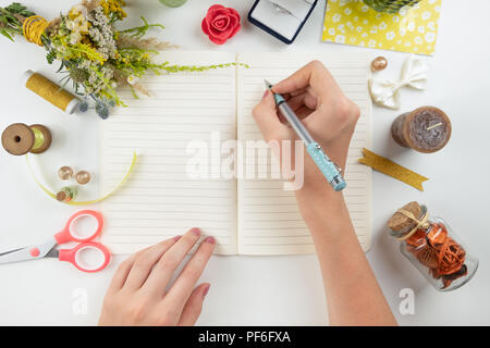 Flat lay of writing memories and emotions into diary. Stock Photo