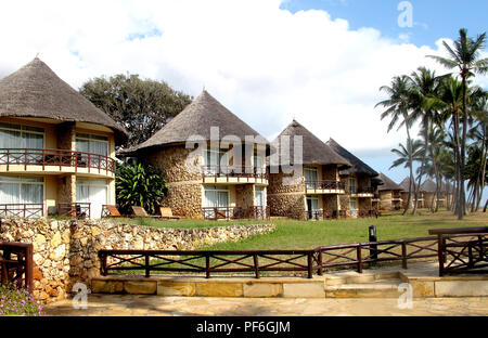 Thatched roof bungalows on the beach of the Crown Plaza Hotel in Dar es Salaam, Tanzania, Africa Stock Photo