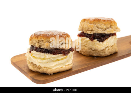 Fresh scones with whipped cream and jam - white background Stock Photo