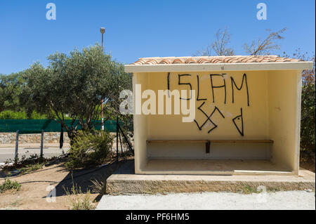 Islamic racist graffiti on a bus shelter in L'Île-Rousse, Corsica, France, Europe Stock Photo