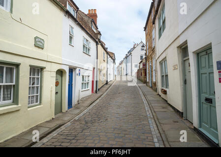 Henrietta Street, Whitby, North Yorkshire, England. An old cobbled street in this popular historic seaside town. Stock Photo