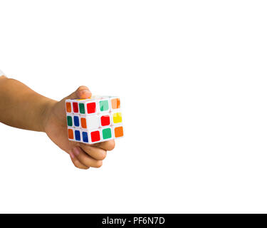 A cropped of female hand holding Rubik Cube against white background include clipping path. Stock Photo