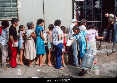 Managua, Nicaragua, June 1986. People queuing to get fresh supplies of cooking calour gas with their documents. Stock Photo