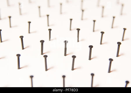 Group of Black concrete nails Galvanized dip color on white paper background Stock Photo
