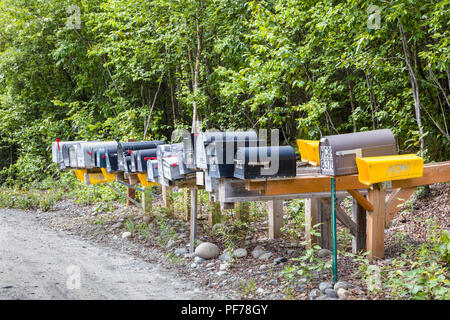 Line of mailboxes along side road Stock Photo