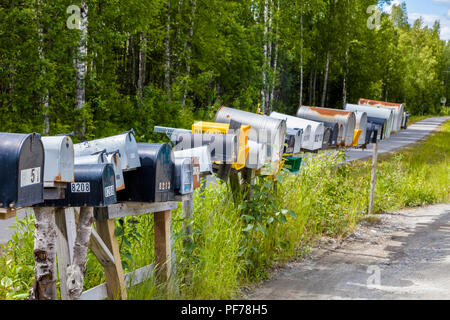 Line of mailboxes along side road Stock Photo