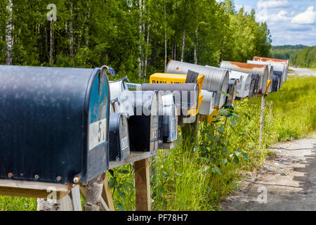 Line of mailboxes along side road Stock Photo