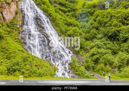 Couple viewing Horsetail Falls in Keystone Canyon on the Richardson Highway in Valdez Alaska Stock Photo