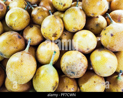 Many fresh yellow granadillas from the market. Stock Photo