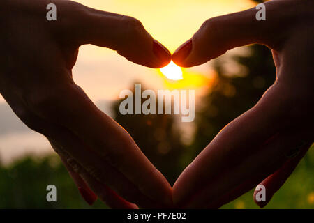 Love Concept, Heart-shape Hand Gesture.Little Girl Made A Heart With Her  Fingers Against The Blue Sky. Stock Photo, Picture and Royalty Free Image.  Image 146977378.