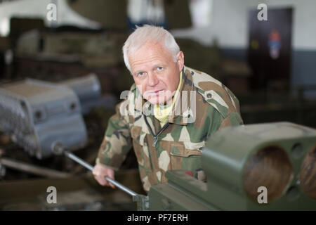 Belarus, Gomel, April 27, 2018. Military factory.Military worker repairing tanks Stock Photo