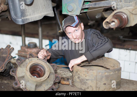 Belarus, Gomel, April 27, 2018. Automobile base. Work car mechanic makes a car.Car repair Stock Photo