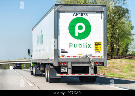 Atlanta, USA - April 20, 2018: Back of Publix grocery store delivery truck closeup on highway road with green sign Stock Photo