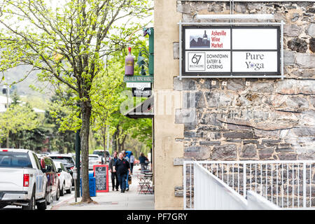 Asheville, USA - April 19, 2018: Downtown old town street in hipster North Carolina NC famous town, city with stores, shops, sign for wine market, Bil Stock Photo
