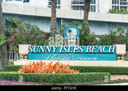 Sign for community city in Sunny Isles Beach, North Miami, Florida, blue words text, by resort, coastline skyscrapers welcome Stock Photo