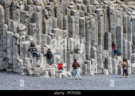 Myrdal, Iceland - June 14, 2018: Reynisfjara black sand beach from volcanic rocks, formation, seashore, coastline, many people, tourists walking, taki Stock Photo